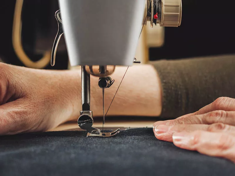 Closeup of hands using a sewing machine