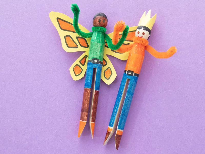 Two beings made out of peg clothespins.